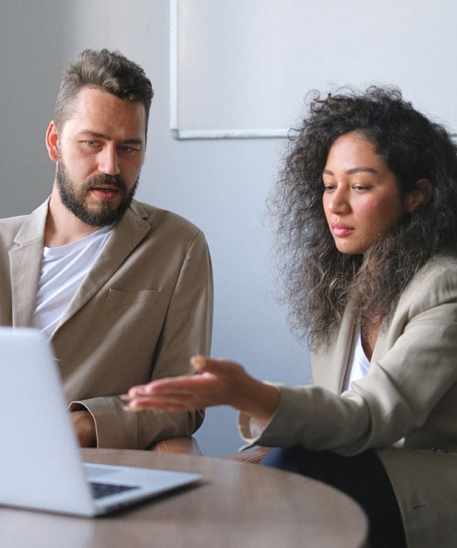 Two Nestor property managers reviewing an owner's monthly report together